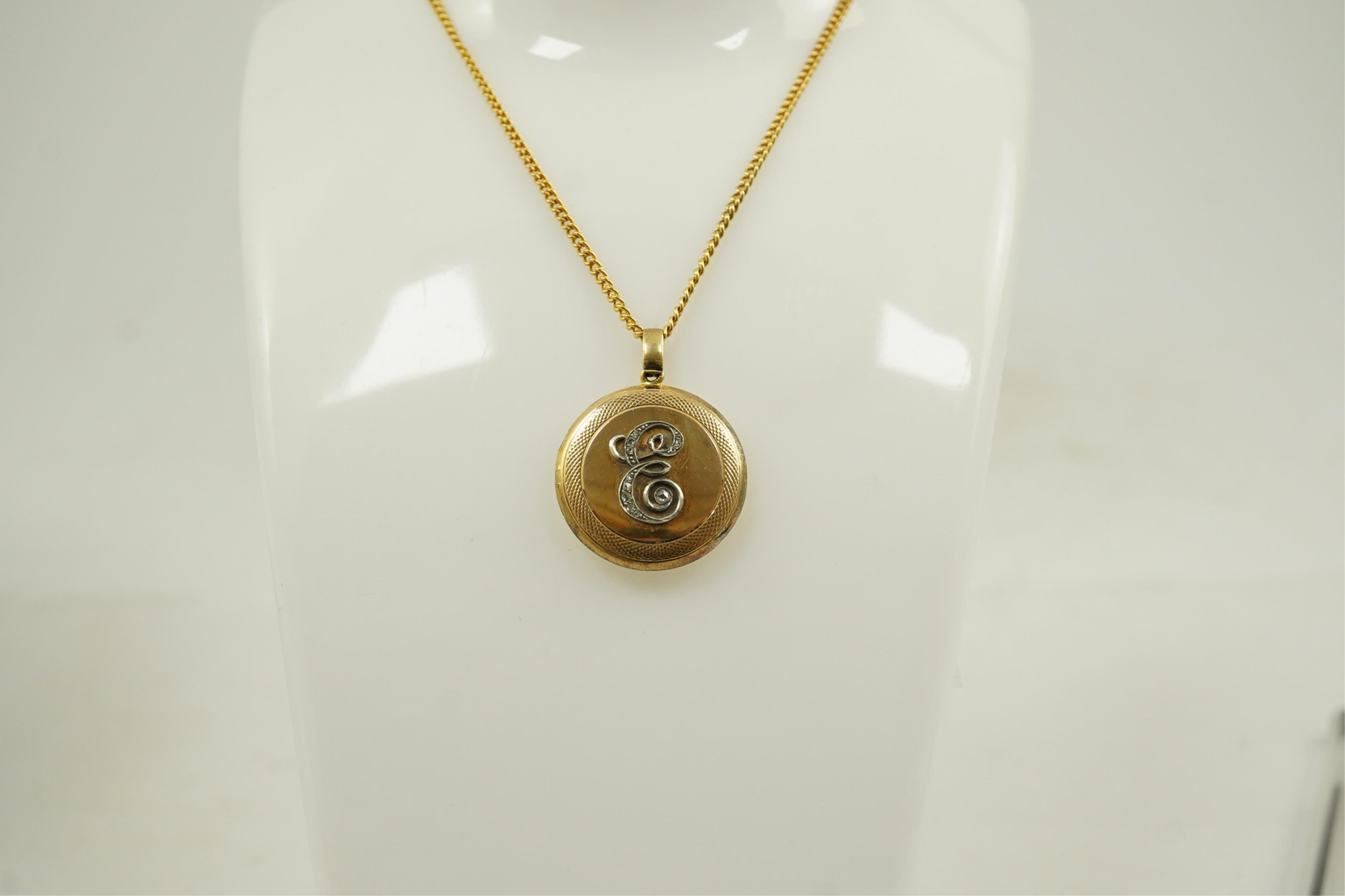 An early to mid 20th century 15ct gold and rose cut diamond cluster set circular 'initial' locket